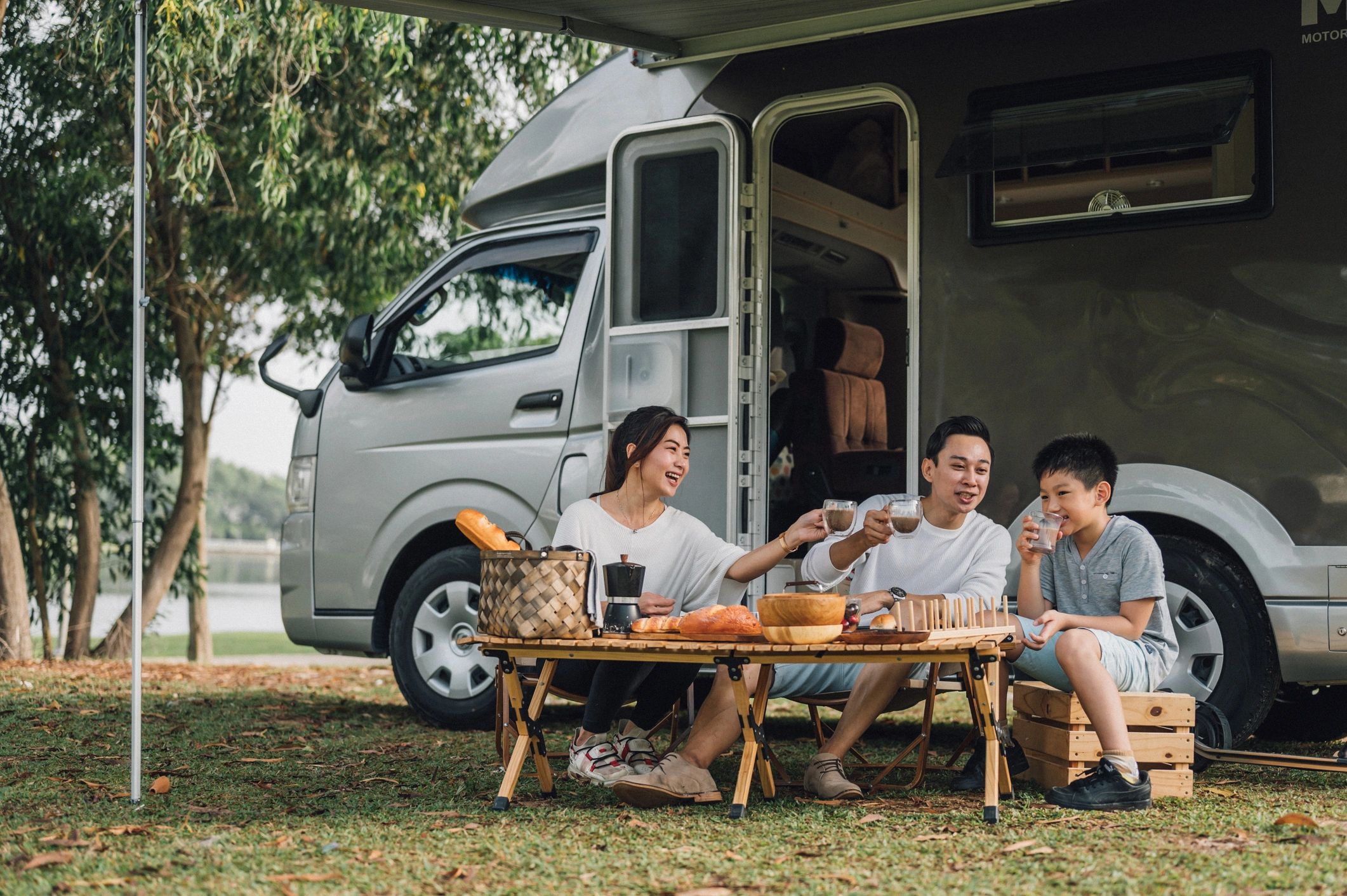 RV owners relaxing at a campsite beside their camper